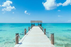 Island-Pier-On-Perfect-Tropical-Beach-With-Blue-Water