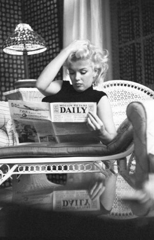 MM15 | Ed Feingersh | Marilyn Monroe reading Motion Picture Daily